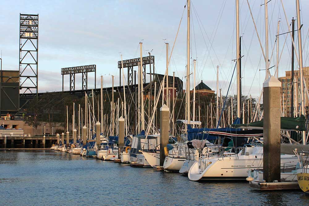 A group of boats sit in a harbor